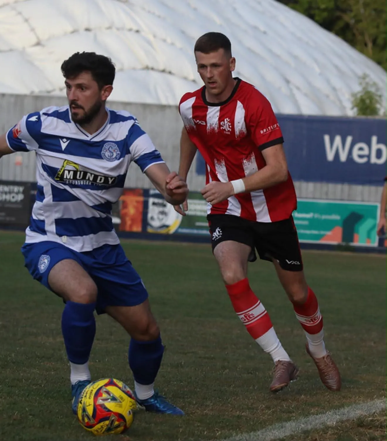 Shaftesbury FC player striking the ball at Shaftesbury Town Stadium